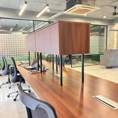 A close-up of the custom workstations, featuring rich wood tones and elevated storage units. The design prioritizes a clean and organized environment to enhance productivity.