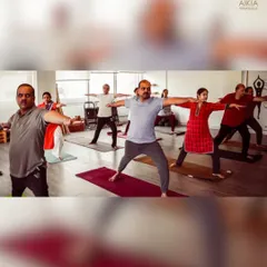 Our inspiring senior yogis practice Virabhadrasana II (Warrior II), demonstrating that strength and stability can be cultivated at any stage of life.