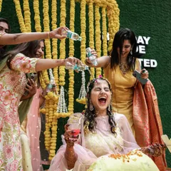 The bride gets a surprise drenching from her friends during the haldi. These are the chaotic, joyful moments that make the best memories.