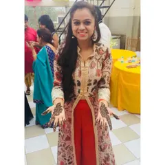 Showing off the beautiful henna design. This outfit, with its long-line printed jacket and comfortable pants, is an ideal choice for a Mehendi function, allowing for easy movement and celebration.