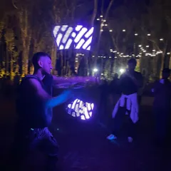 Performing with graphic poi at a night event. These LED props can be programmed to create amazing visual patterns, taking the performance to a whole new level.
