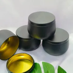 These matte black tin jars with a gold interior provide a sleek and modern container for your handmade candles. They are a stylish choice for creating a high-end candle line.