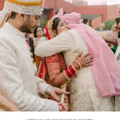 An emotional and poignant moment as the bride hugs her parents goodbye. This image captures the bittersweet tears of leaving home to start a new life, a powerful memory for any family.