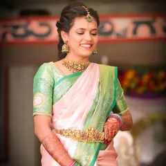 A happy client looking beautiful at a family function. She chose a simple yet elegant temple jewellery set that perfectly complements her silk saree.