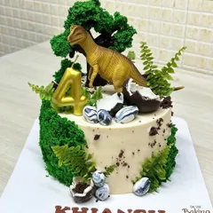 A roaring good time for Khiansh's 4th birthday with this dinosaur theme cake. It features a T-rex, edible moss, chocolate dinosaur eggs, and a rich mango chocolate flavor inside.