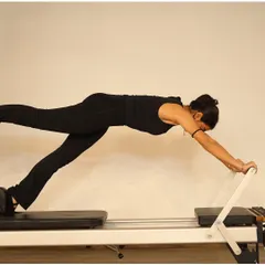 This long stretch on the reformer is a full-body exercise that builds strength in the shoulders, core, and legs, all while improving posture.