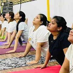 A close-up of our members practicing Bhujangasana, the cobra pose. This is a fundamental backbend that helps strengthen the spine and open the chest.