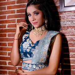 A full look at the teal and silver lehenga, paired with a heavy choker necklace and a stylish high ponytail.