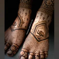 A close-up view of the delicate elephant and lotus motifs, showing the fine detail in this bridal foot design.
