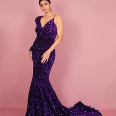 Another elegant pose from the same series, this image captures Daisy Shah in a classic stance that highlights both her poise and the gown's stunning design.