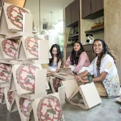 The joy of collaborative creation. At the Brik Oven launch, guests became part of the art, working together to build towers from pizza boxes. This is what experiential art is all about: turning passive guests into active participants.