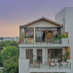 For the Magnolia Residence, a duplex penthouse in Bangalore, we designed an urban oasis. The structure features deep balconies and large windows to merge the indoor living spaces with the outdoors, creating a serene sanctuary that captures city views while maintaining a sense of tranquility.
