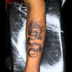 Another view of the completed dragon cover-up tattoo, showcasing the detail in the scales and the fluid motion of the design from a different angle.