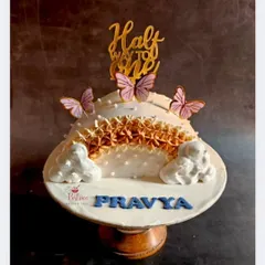 Celebrating a special milestone with a "Halfway to One" cake, adorned with delicate butterflies.