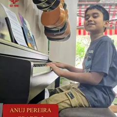 Anuj Pereira at the piano, focused on his sheet music for his Grade 3 exam. Our in studio lessons provide a professional environment for students to learn and grow.