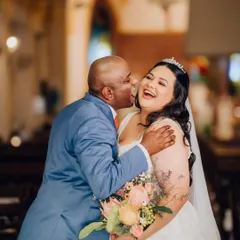 The same beautiful, candid moment from a slightly different angle, capturing the pure happiness and emotion between the bride and her loved one.