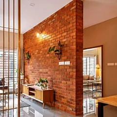 This image shows a functional exposed brick partition wall I built to divide a living and dining area without closing off the space entirely. It adds character while defining the zones.