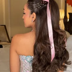 A sweet and angelic half-ponytail for a destination wedding in Jaipur. I added a pretty pink ribbon and scattered pearl details for a touch of fantasy and charm, perfect for a younger client or a fun pre-wedding event.