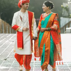 A beautiful Maharashtrian couple taking a stroll, hand in hand. We love capturing the elegance of the traditional Nauwari saree and the groom's vibrant attire.