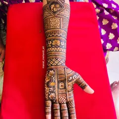 A single-hand view of a bridal design, showing a mix of popular motifs. You can see an elephant in a checkered box at the top, with lotus and peacock figures woven into the pattern below.