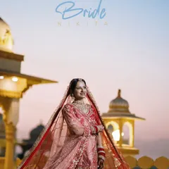 A stunning bridal portrait at dusk against a palace backdrop. The soft light of the sunset and the bride's regal pose create a truly magical and timeless image.
