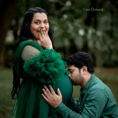 A sweet kiss for the baby bump amidst the beauty of a Bangalore park. This outdoor couple's maternity photo is filled with so much love and happy anticipation.