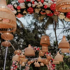 A beautiful boho-inspired floral arch for a beach wedding. The combination of pink and white flowers with hanging wicker lamps creates a dreamy and romantic entrance.