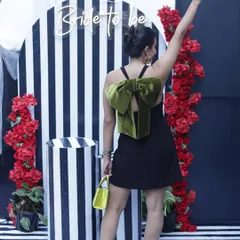 A guest posing in front of the black and white striped backdrop, perfectly capturing the modern and stylish vibe of the event.