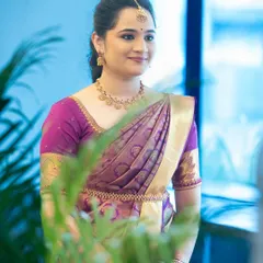 A candid shot capturing her natural elegance. The makeup is subtle, designed to look fresh and effortless for her engagement ceremony.