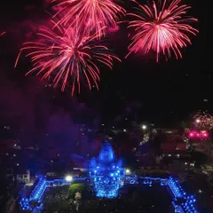 This aerial photo from a Janmashtami celebration in Chittorgarh captures the contrast between the serene, blue-lit temple and the explosive red fireworks, creating a powerful and memorable image.