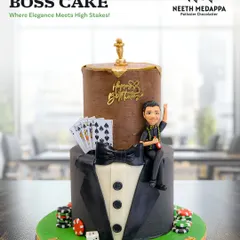 The ultimate boss cake! This two-tiered creation combines a sharp tuxedo design with a casino theme, including cards, chips, and a roulette wheel topper.