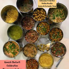 A large buffet-style setup for a Ganesh Chaturti celebration with a full Indo-Chinese menu.