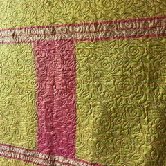 A close-up view of the intricate rose-patterned free-motion quilting we applied to this saree quilt, adding texture without distracting from the fabric's original beauty.