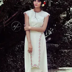 A look from my 'Passage to India' concept shoot, which blends modern silhouettes with traditional Indian details. This white dress features delicate pink embroidery and a contemporary, asymmetrical hemline.