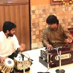 A moment of instruction from my Guruji, Pandit Subhankar Banerjee ji. His guidance on the harmonium, correcting my rhythm and flow, was an integral part of my training.