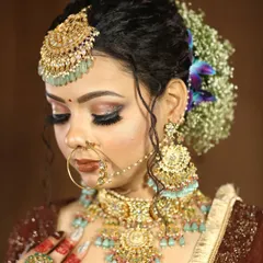 This image showcases a soft brown smokey eye with a touch of shimmer. It's a versatile look that enhances the eyes without being too heavy, paired with a beautiful floral bun.