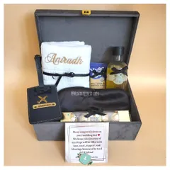 Finding the perfect gift for him can be tricky, but I love the challenge. This hamper, in a classy grey suede box, features a mix of practical and personal items, including an embroidered towel and a custom luggage tag for his travels.