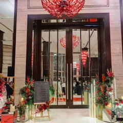 The entrance to this Sangeet at the Taj Santacruz featured striking red chandeliers that contrasted beautifully with the modern, clean lines of the floral arrangements and signage.