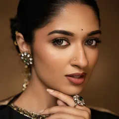 This is my signature soft glam look, perfect for a reception or sangeet. I used airbrush makeup to achieve this dewy, skin-like finish that feels light and looks stunning in photos. The look is completed with a shimmery gold and brown eye and a perfect nude lip.
