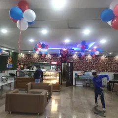 This wide shot shows how I use ceiling balloon bunches and a central hanging foil balloon to carry the party theme throughout the entire restaurant interior.