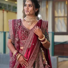A close-up of a bride's reception makeup. The look features defined eyes, a flawless base, and a neutral lip, allowing her magnificent jewellery and outfit to shine.