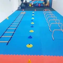 Our training goes beyond traditional drills. We use modern agility and conditioning equipment like ladders, cones, and hurdles to improve footwork, speed, and overall athletic performance for all our students.