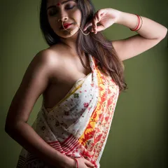 Exploring the theme of 'Moksha' or liberation through a traditional lens. This image uses soft, dramatic lighting to create a sense of intimacy and introspection, focusing on the graceful lines of the saree and the model's serene expression.