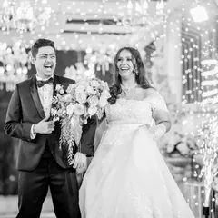 The grand entrance is a moment of pure joy and excitement. I capture this energy in a candid style, focusing on the couple's genuine laughter and happiness as they are welcomed by their loved ones.