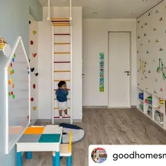 As featured in Good Homes Magazine, this kids' room is designed for play and adventure. It includes a climbing ladder, a rock-climbing wall, and low-level storage bins for easy access to toys.