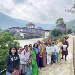 A group photo from our recent Bhutan trip, with the stunning Punakha Dzong fortress in the background. You can see the beautiful jacaranda flowers in bloom, which you find in Bhutan during the spring season.