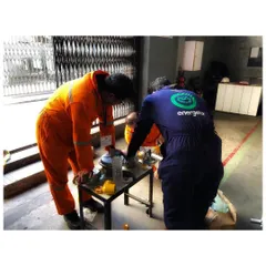 Two of our engineers work together on a piece of equipment on the factory floor. This image captures the hands on, collaborative nature of our on site implementation process.