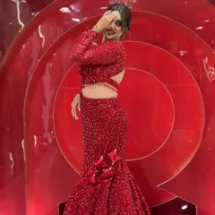 A playful shot of the same viral red sequin fish-cut dress. The back features a stylish cut-out, adding a touch of modern glamour to this showstopper outfit.