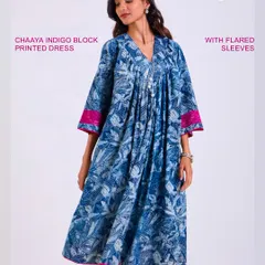 The Chaaya Indigo Block Printed Dress with flared sleeves. The combination of a relaxed silhouette, intricate print, and a pop of pink at the cuffs makes this a standout piece for any day.