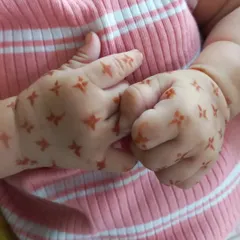 How sweet are these little hands? I applied a simple pattern of tiny four-petaled flowers, which is a great option for very young children who can't sit still for long.